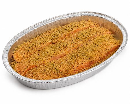 Breaded salmon in a foil baking pan, ready to bake